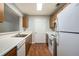 Functional kitchen with white appliances, wooden cabinets, and spacious countertops at 13304 Waldrop Cv, Decatur, GA 30034