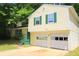 Inviting home featuring a two-car garage and classic siding at 2238 Scarbrough Dr, Stone Mountain, GA 30088