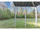Under-deck view of the wooded backyard shows the landscape beyond the home at 7746 New Castle Way, Jonesboro, GA 30236