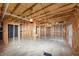 Unfinished basement shows exposed ceiling and framing for future rooms at 7746 New Castle Way, Jonesboro, GA 30236