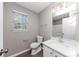 Well-lit bathroom featuring a large mirror, toilet, shower and single sink with vanity at 7746 New Castle Way, Jonesboro, GA 30236