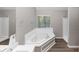 Bright bathroom features a large soaking tub, separate shower, and modern vanity at 7746 New Castle Way, Jonesboro, GA 30236