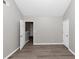 Cozy bedroom featuring hardwood floors, neutral paint, and natural light from the door at 7746 New Castle Way, Jonesboro, GA 30236