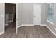 Comfortable bedroom with hardwood floors, natural light, and ample closet space at 7746 New Castle Way, Jonesboro, GA 30236