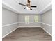 Spacious bedroom boasts hardwood floors, a ceiling fan, and ample space for furniture at 7746 New Castle Way, Jonesboro, GA 30236