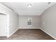 Bright bedroom features hardwood floors, neutral paint, natural light from the window, and ample space at 7746 New Castle Way, Jonesboro, GA 30236