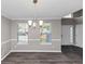 Modern dining room with wood-like floors, gray walls, and ample natural light coming through the windows at 7746 New Castle Way, Jonesboro, GA 30236