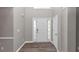 Welcoming entrance features a light gray wall, a white front door with glass panes, and wood-like floors at 7746 New Castle Way, Jonesboro, GA 30236