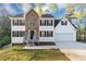 Charming home featuring a stone facade, black shutters, and a manicured front yard at 7746 New Castle Way, Jonesboro, GA 30236