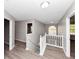 Hallway with hardwood floors, neutral paint, natural light, and staircase to the second floor at 7746 New Castle Way, Jonesboro, GA 30236