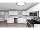Modern kitchen featuring white cabinets, stainless steel appliances, and ample counter space at 7746 New Castle Way, Jonesboro, GA 30236