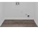 Modern laundry room with hardwood floors and washing machine hookups at 7746 New Castle Way, Jonesboro, GA 30236