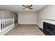 Inviting living room with hardwood floors and fireplace, with staircase visible for easy access to other levels at 7746 New Castle Way, Jonesboro, GA 30236