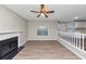 Spacious living room highlighting hardwood floors, fireplace, and windows for abundant natural light at 7746 New Castle Way, Jonesboro, GA 30236