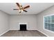 Bright living room featuring a ceiling fan, fireplace and hardwood floors, blending comfort and functionality at 7746 New Castle Way, Jonesboro, GA 30236