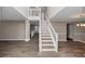 Bright and airy staircase with wood-like floors and white railing, leading to the second floor at 7746 New Castle Way, Jonesboro, GA 30236