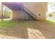 The back of this home features a wooden deck with stairs and a lush green lawn at 116 Shefield Pl, Douglasville, GA 30134