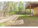 This home's backyard features green grass and is partially shaded by mature trees at 116 Shefield Pl, Douglasville, GA 30134