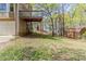 Home's backyard features a wooden deck with stairs, a small shed, and plenty of green space at 116 Shefield Pl, Douglasville, GA 30134