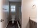 Cozy bathroom with a toilet, window, vanity sink, and a towel rack at 116 Shefield Pl, Douglasville, GA 30134