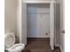Full bathroom and laundry area with modern fixtures and dark wood-look flooring at 116 Shefield Pl, Douglasville, GA 30134