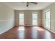 Spacious bedroom with hardwood floors, ceiling fan, neutral paint and multiple windows offering lots of natural light at 116 Shefield Pl, Douglasville, GA 30134