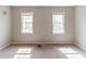 Bedroom showcasing two large windows, carpeted flooring, and light colored walls at 116 Shefield Pl, Douglasville, GA 30134