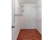 Walk-in closet with built-in shelving and modern wood-look flooring at 116 Shefield Pl, Douglasville, GA 30134