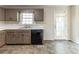 A kitchen with painted cabinets, a black dishwasher, and an exterior door at 116 Shefield Pl, Douglasville, GA 30134
