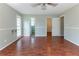 Large main bedroom featuring a ceiling fan, two windows, and hardwood flooring with access to a closet and bathroom at 116 Shefield Pl, Douglasville, GA 30134