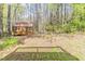 A wooden shed located in a backyard surrounded by mature trees, and greenery at 116 Shefield Pl, Douglasville, GA 30134