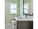 Well-lit bathroom featuring a modern vanity with a quartz countertop and patterned tile flooring at 1741 Hasty Rd, Marietta, GA 30062