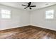 Charming bedroom with hardwood floors and ceiling fan, illuminated by natural light through windows at 1741 Hasty Rd, Marietta, GA 30062