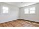 Bright bedroom featuring hardwood floors and two windows for natural light at 1741 Hasty Rd, Marietta, GA 30062