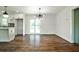 Open dining space with modern chandelier and hardwood floors, seamlessly connects to kitchen and patio at 1741 Hasty Rd, Marietta, GA 30062