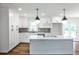 Modern kitchen featuring white cabinets and stylish lighting, and a center island with quartz countertops at 1741 Hasty Rd, Marietta, GA 30062