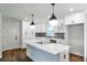 Modern kitchen featuring white cabinets, a center island with quartz countertops, and stylish pendant lighting at 1741 Hasty Rd, Marietta, GA 30062