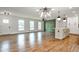 Spacious living room with hardwood floors, modern lighting, and open floorplan to kitchen at 1741 Hasty Rd, Marietta, GA 30062