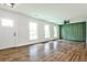 Inviting living room with hardwood floors and modern green feature wall at 1741 Hasty Rd, Marietta, GA 30062