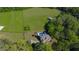 Beautiful aerial view of an estate with a pool, lush green lawn, and surrounding mature trees at 20 Rivercreek Xing, Kingston, GA 30145