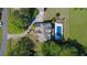Aerial view of the home with long driveway, inground pool, patio, and surrounding greenery at 20 Rivercreek Xing, Kingston, GA 30145