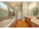 Luxurious bathroom with a soaking tub, a glass shower, and dual vanities at 20 Rivercreek Xing, Kingston, GA 30145