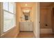 Well-lit bathroom featuring a vanity, large mirror, and combination bathtub and shower at 20 Rivercreek Xing, Kingston, GA 30145