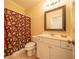 Traditional bathroom featuring a vanity, toilet, and a floral shower curtain at 20 Rivercreek Xing, Kingston, GA 30145