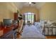Bedroom with a high ceiling, a comfortable daybed, and large window overlooking the yard at 20 Rivercreek Xing, Kingston, GA 30145