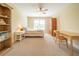 Bright bedroom featuring a ceiling fan, large window, writing desk, and built in bookshelf at 20 Rivercreek Xing, Kingston, GA 30145