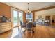 Sunlit dining room with hardwood floors, leading to outdoor deck and Gathering room at 20 Rivercreek Xing, Kingston, GA 30145
