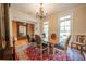 Traditional dining room features a chandelier, large windows, and a decorative cabinet at 20 Rivercreek Xing, Kingston, GA 30145