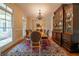 Elegant dining room with a chandelier, large windows, a wooden table, and a decorative area rug at 20 Rivercreek Xing, Kingston, GA 30145