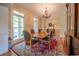 Bright dining room features hardwood floors, chandelier, and large windows providing natural light at 20 Rivercreek Xing, Kingston, GA 30145